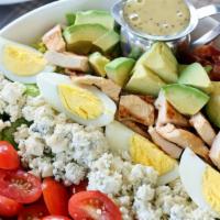 Traditional Cobb Salad · Avocado, bacon, tomato, blue cheese, hard boiled egg and grilled chicken with a poppy Dijon ...