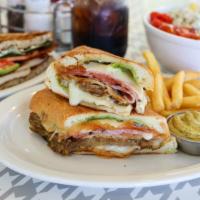 The Cuban · Traditional pressed sandwich on Cuban bread made with roasted pork, ham, melted Swiss, mojit...