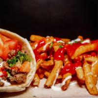 Gyro Wrap With Fries  · Fresh pita bread filled with gyro, crisp lettuce and sautéed onions drizzled with white sauc...
