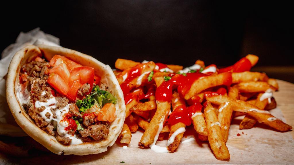 Gyro Wrap With Fries  · Fresh pita bread filled with gyro, crisp lettuce and sautéed onions drizzled with white sauce served with a generous serving of fries.
