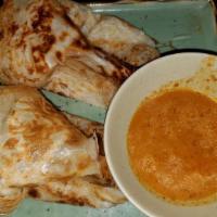Roti Canai · With curry dipping sauce.