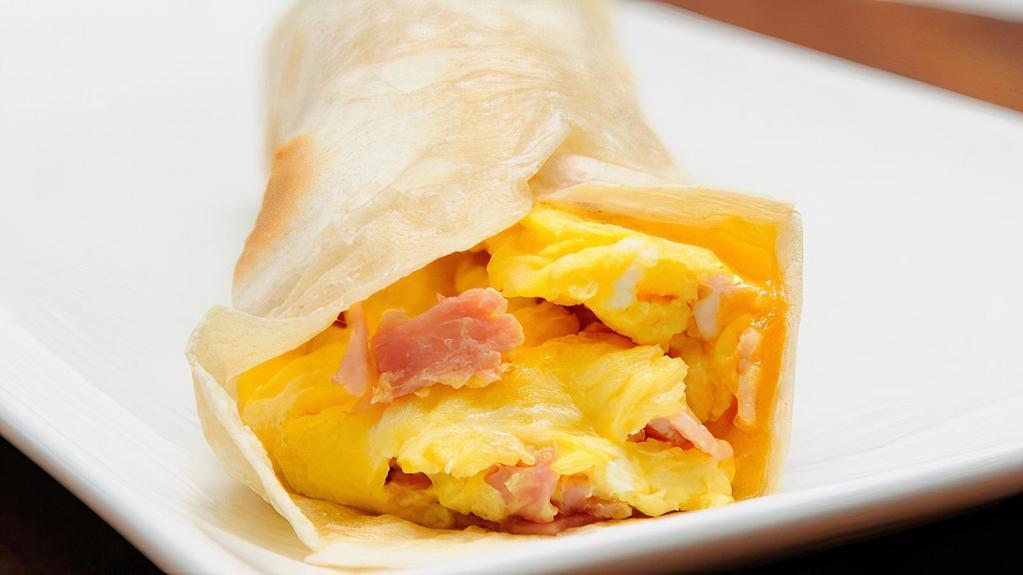 Classic Egg Wrap · Delicious Breakfast wrap topped with Ham, Two Eggs, Cheese & Home Fries. Served on customer's choice of wrap.