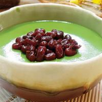 Matcha Pudding With Red Beans · Matcha pudding topped with red bean, milk creamer on the side.