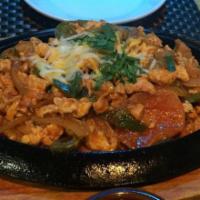 Chicken Fajitas · Mixed with onions, peppers, and tomatoes. Served with rice, beans and homemade tortillas.