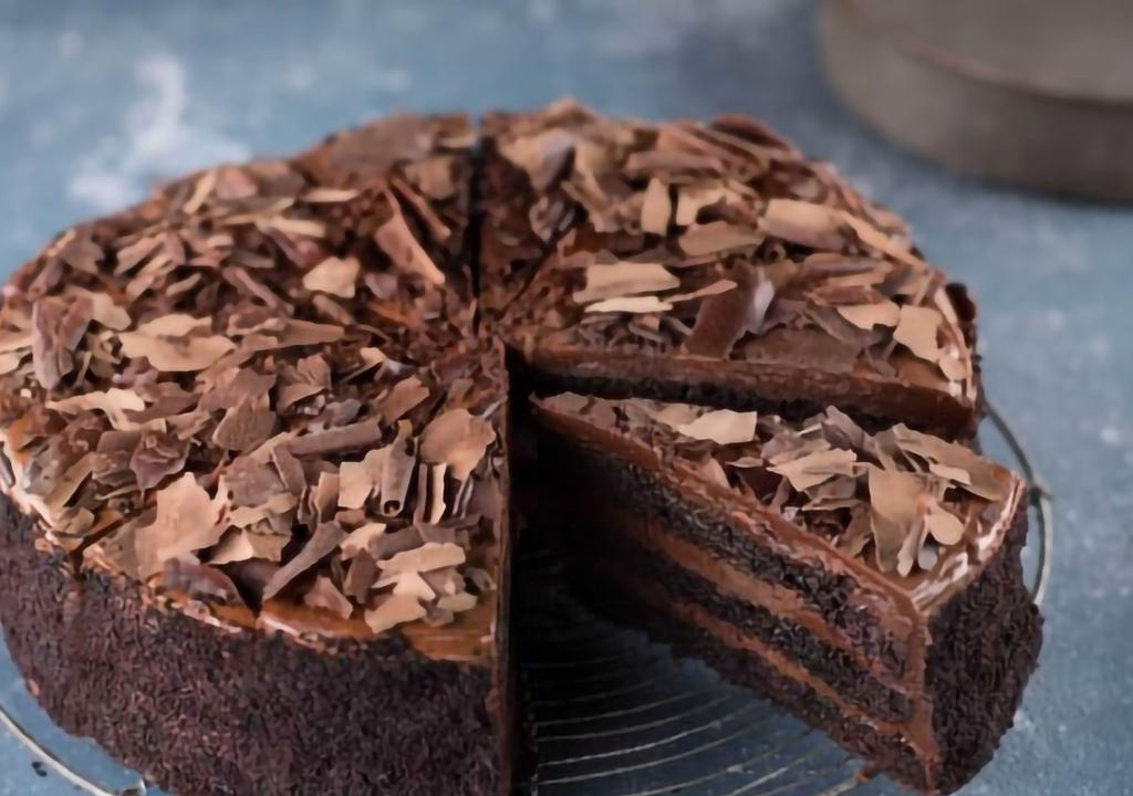 Chocolate Fudge Cake (Slice) · Alternating layers of rich fudgy cake and smooth chocolate butter cream, covered with chocolate shavings.