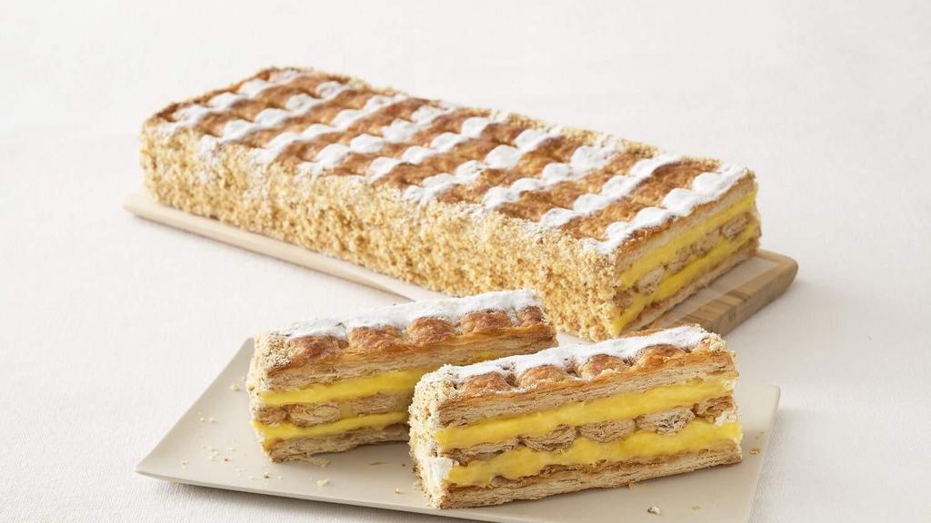 Napoleon (Slice) · Crisp layers of puff pastry filled with pastry cream and decorated with powdered sugar.