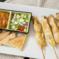 Chicken Satay · Marinated chicken skewer served with peanut sauce and cucumber sauce.