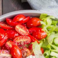 House Salad · Tomato, cucumber, roasted peppers, black & green olives, and shredded mozzarella cheese over...
