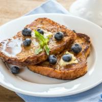 Blueberry French Toast · Sliced challah bread soaked in eggs and milk, then fried and topped with blueberries served ...