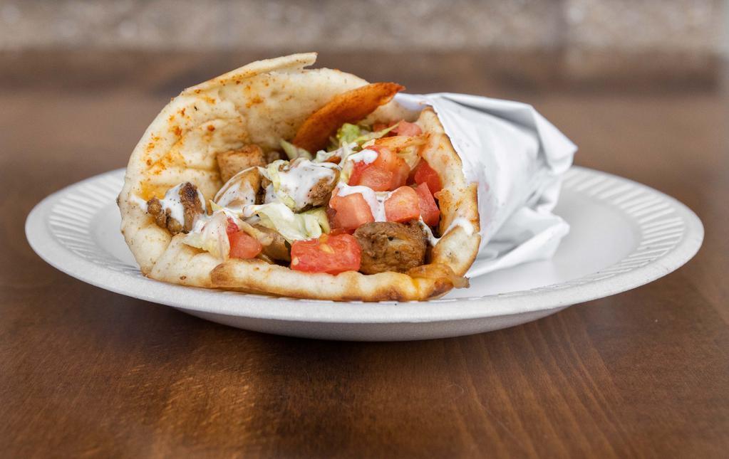 Chicken Gyro Wrap · Slightly spicy Chicken gyro wrapped in pita bread with lettuce, tomato, onions and white sauce.