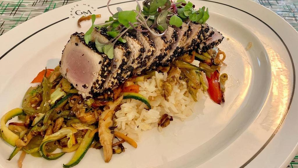 Seared Sesame Tuna · Served with stir fried veggies, ginger, ponzu, Over Rice.