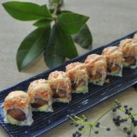Dynamite Roll · Tuna, salmon, avocado, topped with spicy crunchy Kani, tobiko, and chef sauce.