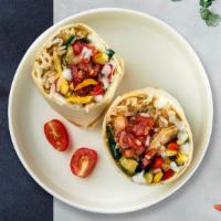 Veggie Burrito · Grilled seasonal vegetables topped with sour cream, salsa, cheese, and spanish rice wrapped ...