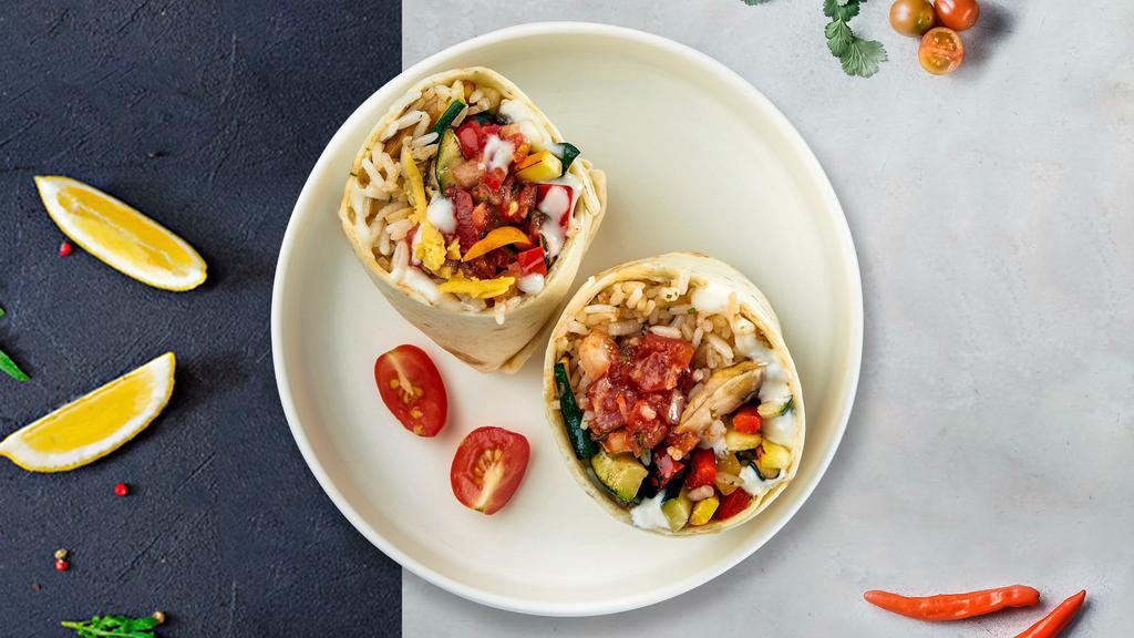 Veggie Burrito · Grilled seasonal vegetables topped with sour cream, salsa, cheese, and spanish rice wrapped in a warm tortilla with pico de gallo.