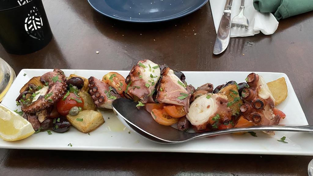 Polpo Alla Griglia Con Patate Tiepide · Grilled octopus with cherry tomatoes capers taggiasca olives warm potatoes in a lemon citronette.
