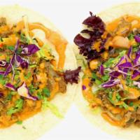 Poción Tacos · Gluten free. Contains soy. Soft corn tortillas, vegan carnitas, picadillo, red cabbage, and ...