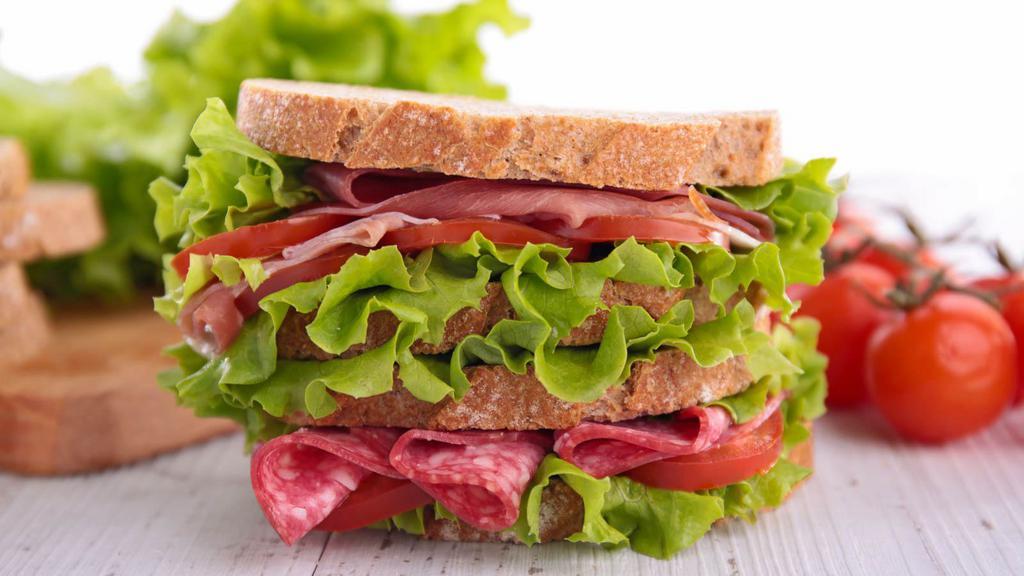 Salami Sandwich · Fresh avocado, pesto, olives, tomatoes, salami, and mozzarella on your choice of bread. Served with a salad on the side.