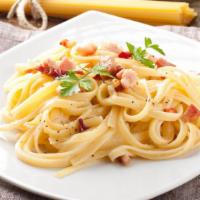 Linguine Carbonara · Crispy bacon, sweet peas, mushrooms, and creamy alfredo sauce on a bed of linguine pasta. Ch...