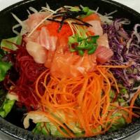 Sashimi Over Rice · little pieces of Sashimi and vegetables over rice and sweet and spicy sauce on the side with...