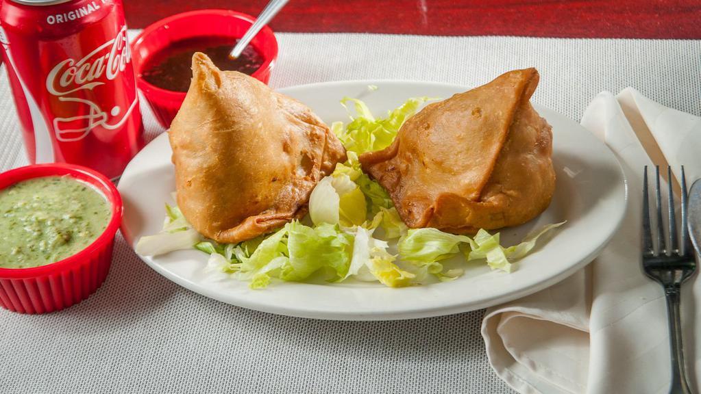 Samosa - 2 Pcs · Golden crisp triangle filled with mildly spice potatoes and peas.