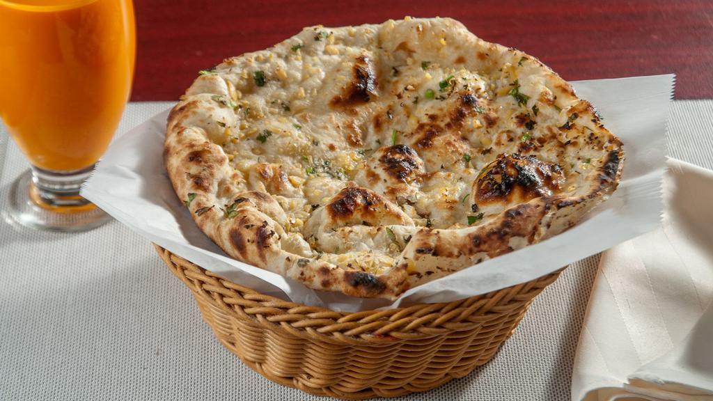 Garlic Naan · Unleavened bread topped with mildly spiced fresh garlic and cilantro.