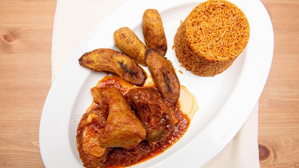Jollof Rice · Traditional west African rice made with tomatoes, onion, and red pepper and comes with choice of chicken, beef, goat, or fish and one side.