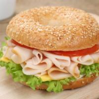 Turkey, Egg & Cheese Bagel · Turkey slices on egg and cheese bagel sandwich.