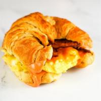 Bacon, Egg And Cheddar Croissant Sandwich · 3 fresh cracked cage-free scrambled eggs, melted 2 scrambled eggs, melted Cheddar cheese, sm...