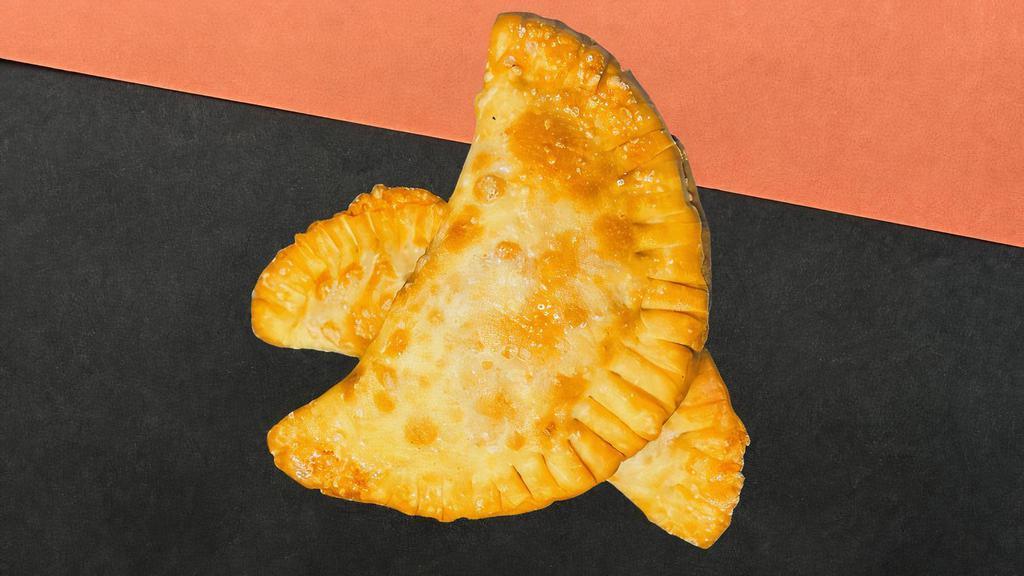 Vegan Curry Chik'N N Empanada · Flavorful and bold Curry Chik'n trapped inside crunch heaven!