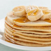 Banana Buttermilk Pancakes · 3 pcs fresh buttermilk pancakes topped with bananas with a side of butter and syrup.
