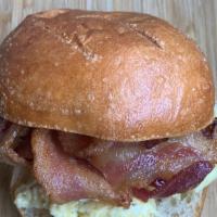Bacon & Egg Sandwich · Scrambled eggs with bacon, white cheddar and chili flakes on a toasted brioche bun.