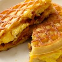 Waffle And Egg Sandwich · A fried egg with melted cheddar cheese and mayo sandwiched between two fluffy Belgian waffles.