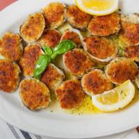 Baked Clams · Prepared in a breadcrumb seasoning. served with a lemon wedge. served with a piece of italia...