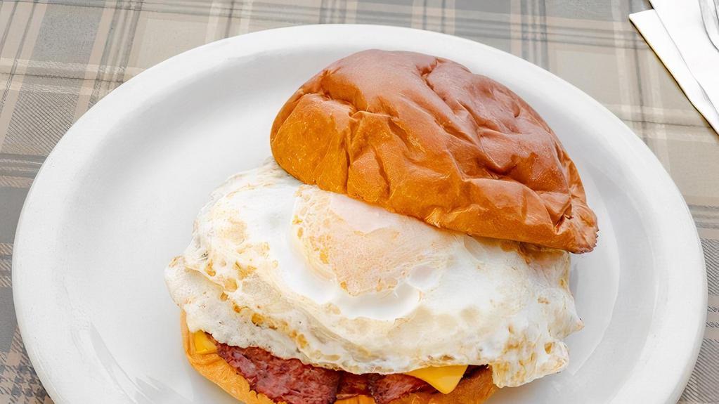 Breakfast Sandwich · Pork roll, 2 over easy eggs, and American cheese served on a brioche bun.