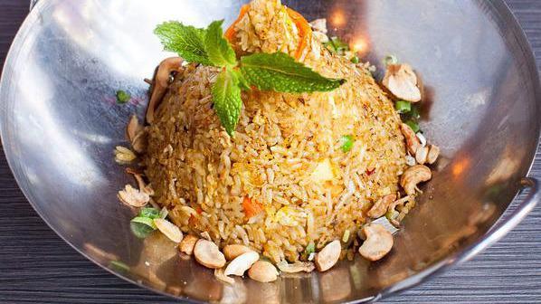 Fragrant Pineapple Fried Rice · Vegetarian. Lemongrass, galangal, turmeric, torch ginger, coriander, onion, bell pepper, tamarind, and cashew nuts. Mild spicy.