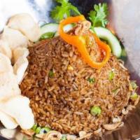 Thai Style Fried Rice · Thai sweet soy sauce blend in a hot clay pot, eggs, cucumber, carrot, peas, cilantro, and sh...