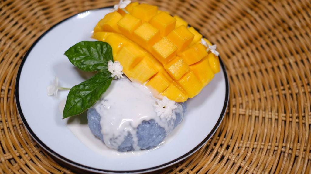 Mango Sticky Rice · Sweet Mango with Coconut Sticky Rice infuse with the Butterfly Pea Flower. Topped with roasted sesame.
