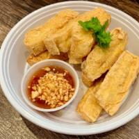 Fried Tofu (V) · Golden-fried tofu, served with sweet chili sauce topped with ground peanut. Vegetarian.