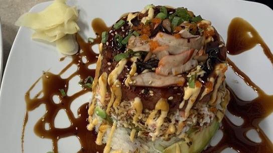 Tuna Tower · Over rice, spicy tuna, crab salad, avocado, squid salad, masago, scallion, spicy sauce, teriyaki sauce.