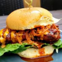 Korean Fried Chicken Sandwich · Fried Chicken Thigh, Gochujang Glaze, Soy Pickled Carrots, Kimchi Mayo, and Crispy Romaine.