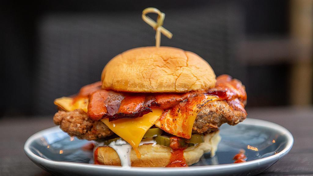 Buffalo Chicken Sandwich · American cheese, bacon, house pickles, pickled jalapenos, white BBQ and buffalo sauce.