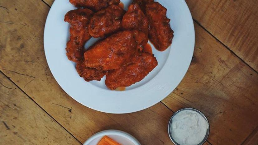 Spicy Buffalo Wings · A classic favorite! Made with our own house-made buffalo sauce and served with house-made bleu cheese dressing, pickled white mu radish and carrots