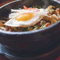Bulgogi Bibimbap 불고기 비빔밥 · Traditional Korean rice bowl with lightly seasoned and sautéed vegetables and bulgogi, toppe...