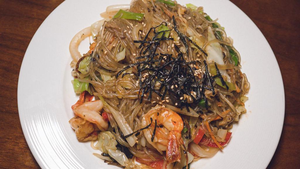 Japchae · Stir-fried cellophane sweet potato noodles with sesame oil, soy sauce, cabbage, onion, woodear mushroom, red peppers