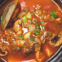 Soondubu Chigae 순두부찌개 · Spicy and savory stew with silken tofu and seafood (mussels, shrimp, squid and clams). Serve...