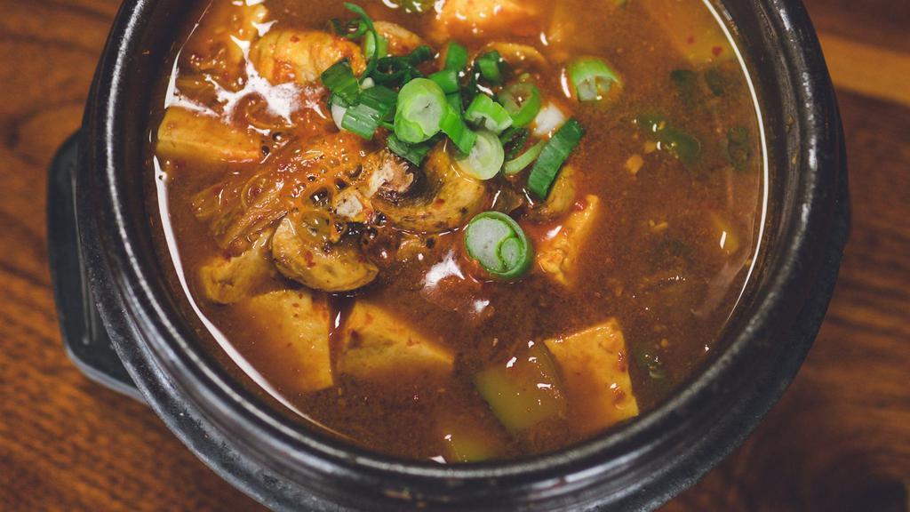 Denjang Chigae 된장찌개 · Spicy and pungent bean-paste (miso flavor) stew with tofu, Korean pepper, zucchini, mushroom, onion, potatoes. Your choice of white rice or Dokebi Purple (mixed grain) rice. Spicy.