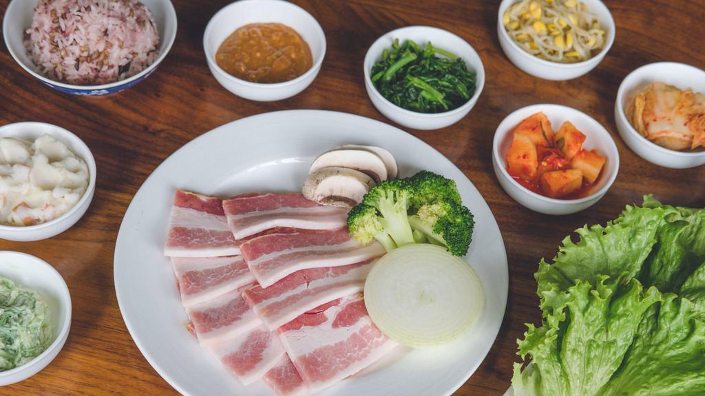Diy Smoked Berkshire Pork Belly (Uncooked) · Uncooked and sliced smoked Berkshire pork belly  with onions, garlic, Korean peppers. Served with your choice of white rice or Dokebi Purple (mixed grain) rice, a side of a bean paste, and traditional side dishes (banchan)