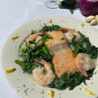 Salmon Somerset · Grilled salmon and shrimp over sautéed broccoli rabe, garlic and white wine sauce
