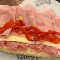 Italian Combo · Imported ham, mortadella, soppressata, provolone, roasted peppers, and vinaigrette.