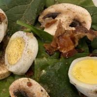 Spinach Salad · Baby Spinach leaves, hard boiled eggs, smoked bacon plus mushrooms topped with a sweet vineg...